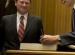 Chief Justice John Roberts Jr. looks on as then-President-elect Barack Obama signs a guest book.  