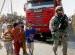 US soldier stands guard with children in Basra, Iraq.