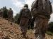 Soldiers climb hill in Afghanistan.