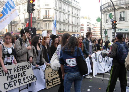 Members of a national union of high school students. One sign reads : "Repressive state, depressive people"; a girl's sweatshirt has the logo "Rêve générale," which is a rhyme and a play on the words "grève générale," or general strike, than means "general dream."