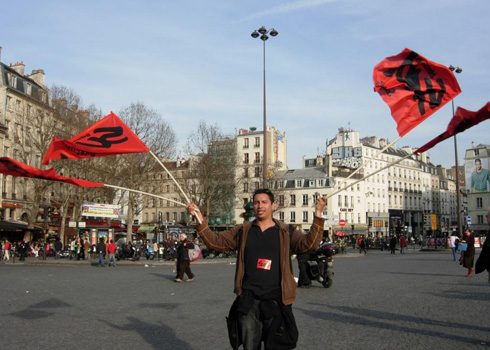 Young man displaying flags of the union "Sud," one of the most left-leaning confederations.